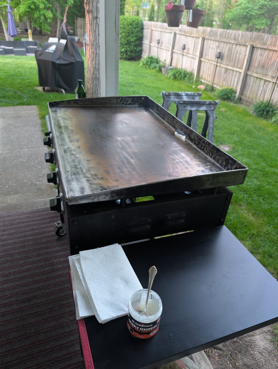 Close-up of restored Blackstone griddle surface with dark seasoning patina